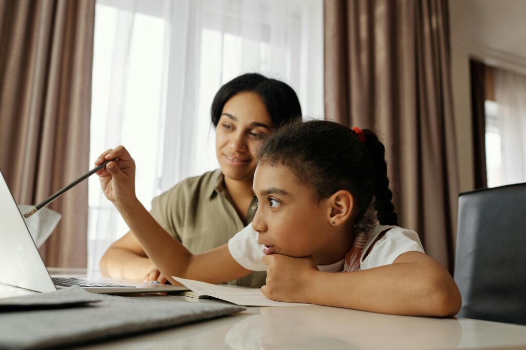 pexels photo 4260315 4260315 Mother and daughter engaged in online learning at home, using a laptop.